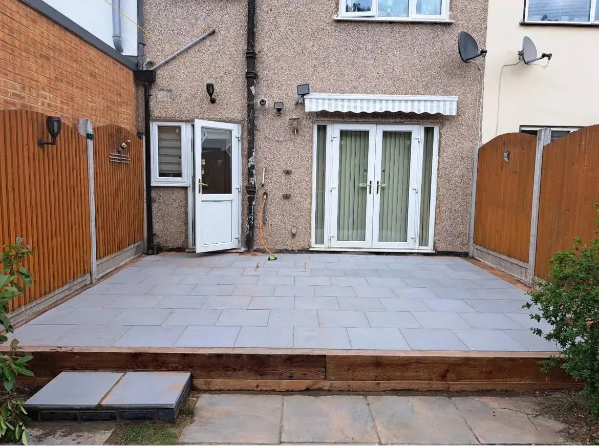 Newly completed modern garden patio featuring large grey slabs